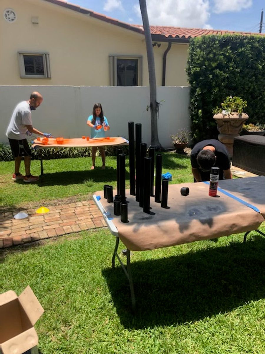 Pipes drying on a table in the backyard during a paint day