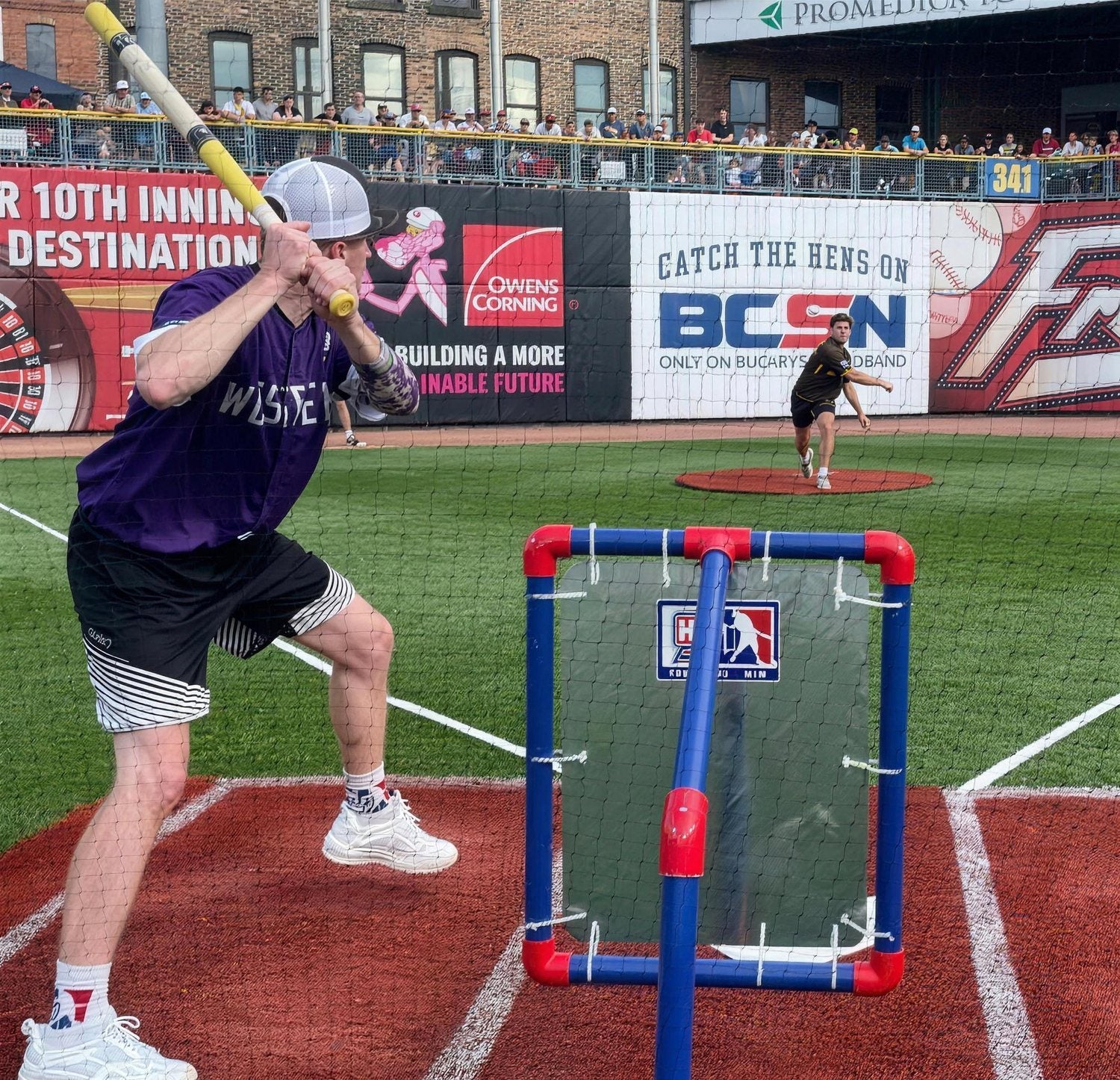 A batter at the plate in a pro ballpark with a Home Stand strike zone behind him